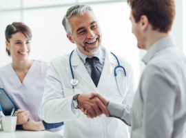 Smiling,Doctor,At,The,Clinic,Giving,An,Handshake,To,His